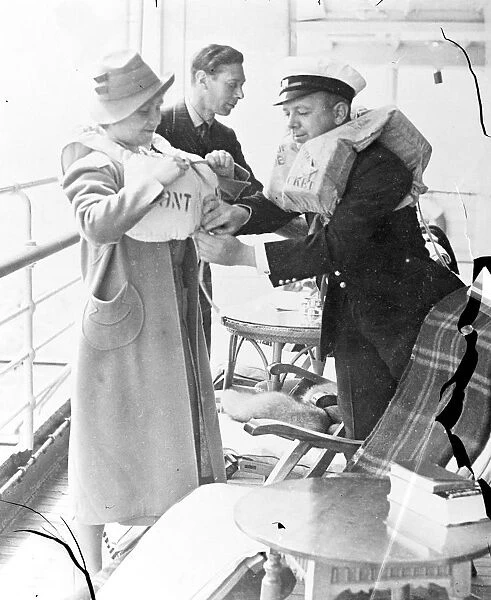 The King and Queen trying on their lifebelts on the liner Empress of Australia