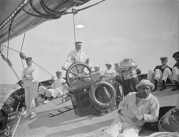 The King takes the wheel of his yacht Britannia. HM at the wheel. 7 August 1924