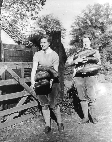 Land Army Girls carrying loaves of bread
