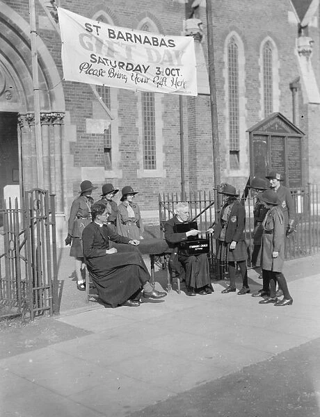 A little girl gives money to the collectors for St Barnabas Church in Eltham, Kent