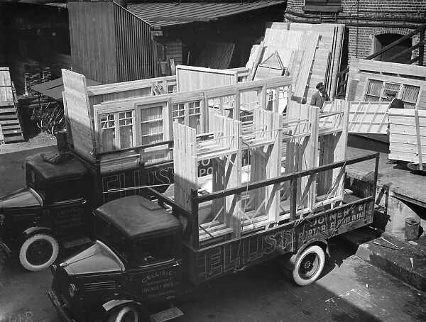 Loading Bedford lorrys at the G Ellis joinery works in Hackney. 7 April 1938