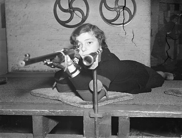 London office girls become expert with the rifle. Girls employed in the offices
