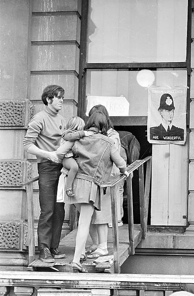 London: A women and child is assisted by squatters to enter the empty 60 room mansion a 144