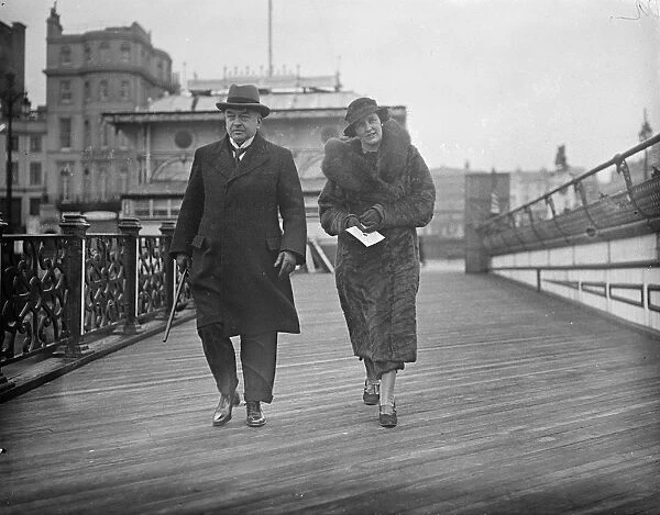 The Lord Chief Justice, Lord Hewart, walking along the pier at Brighton with his new bride
