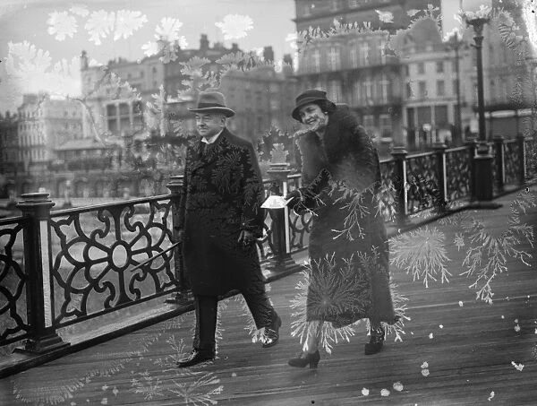 The Lord Chief Justice, Lord Hewart, walking along the pier at Brighton with his new bride