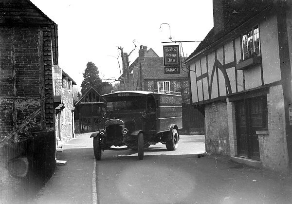 Lorry driving past Ye Old George In garage in Shoreham. 1934