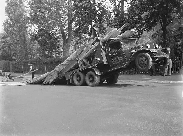 A lorry tips backwards spilling its load in Sevenoaks, Kent. 1935
