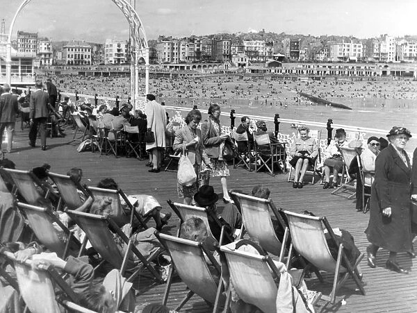 A lovely Summer day on Brighton Pier, East Sussex, England, with the crowded beach