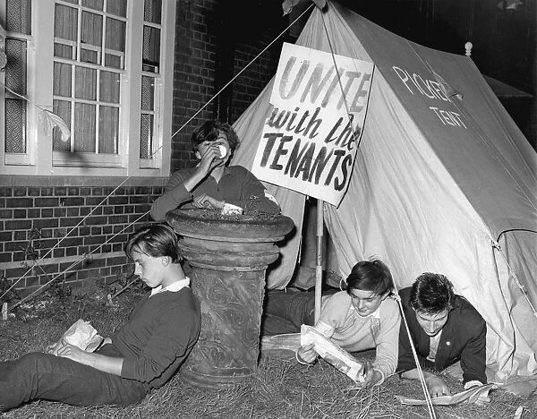 Lying close to their picket tent, youngsters keep a lonely vigil outside Kennistoun House
