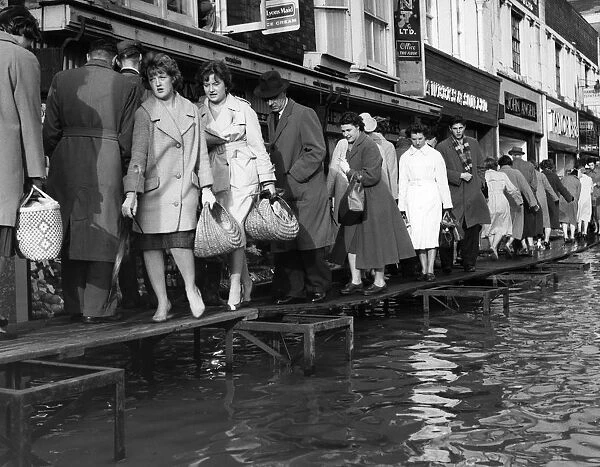This is how Maidstone coped with the floods in the Main Street, to enable housewives