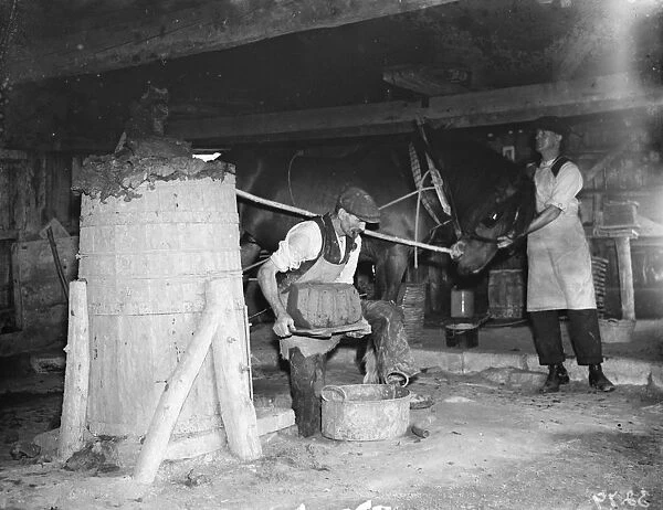 Making clay bricks using a horse powered press. 1936