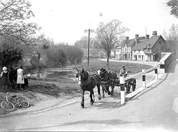 A man drives his cart pulled by shire horses through Eynsford, Kent. 1934