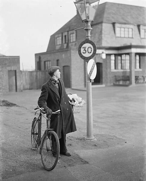 A man looking at a 30 miles per hour speed limit sign in Birchwood, Kent