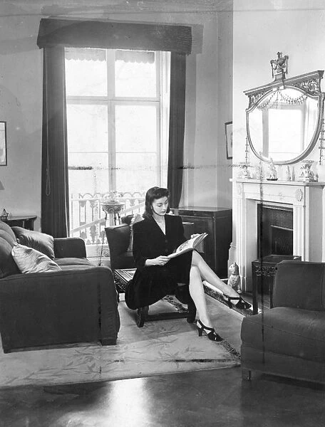 Margot Fonteyn at home. A quiet read by the fireside before leaving for the Royal Opera House