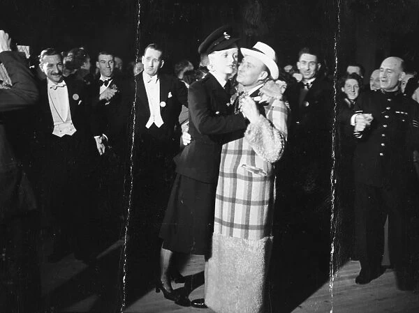 Max Miller, looking quite at home in the arms of the law, pictured dancing with