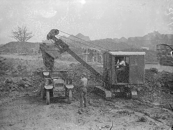 A mechanical navvy carrying away the spoil during the excavations on the site of