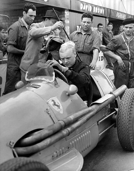 Mike Hawthorn with the Ferrari he drove in the British Grand Prix at Silverstone