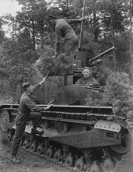 Military operations at Aldershot. Members of the Tank Corps camouflaging their tanks