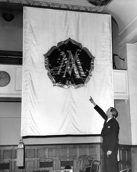 A Ministry of Works Official examining one of the banners, which will be used in