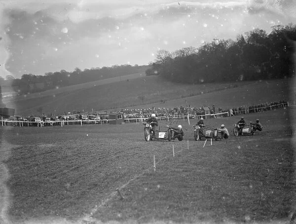 Motor cycling races at Brands Hatch. The side car bikes take a corner during the