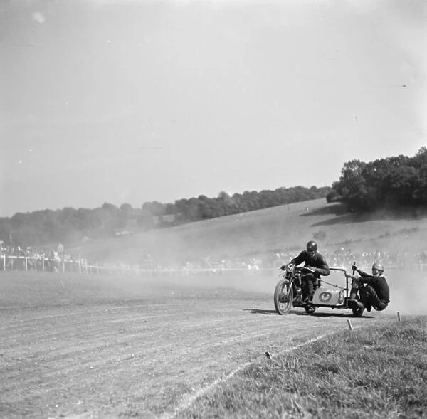 Motorcycle racing at Brands Hatch, Kent. A sidecar motorbike takes a corner