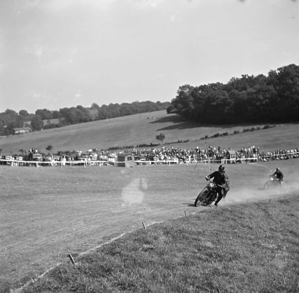Motorcycle racing at Brands Hatch, Kent. Two motorbike take a corner. 1936