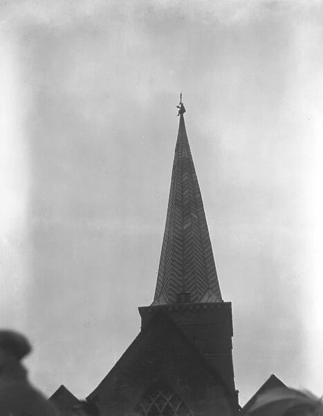 Mr Ager, the steeplejack, on top of the spire of Godalming church, retrieves a
