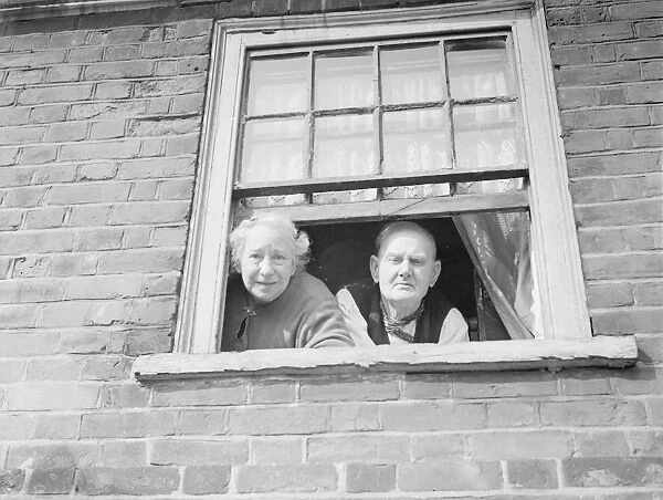 Mr George Dowe and and Mrs Dowe looking out of their window in Northfleet, Kent