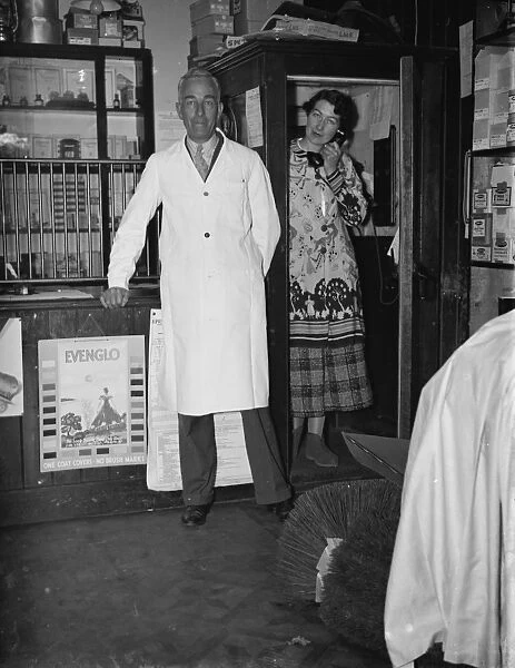 Mr George May, Postmaster of Downe, Kent by his Post Office counter with his wife