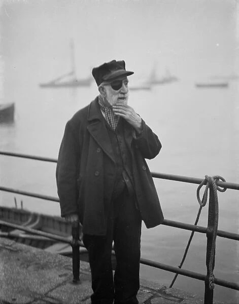 Mr L M Allen of Gravesend strokes his beard in a pose. 1938