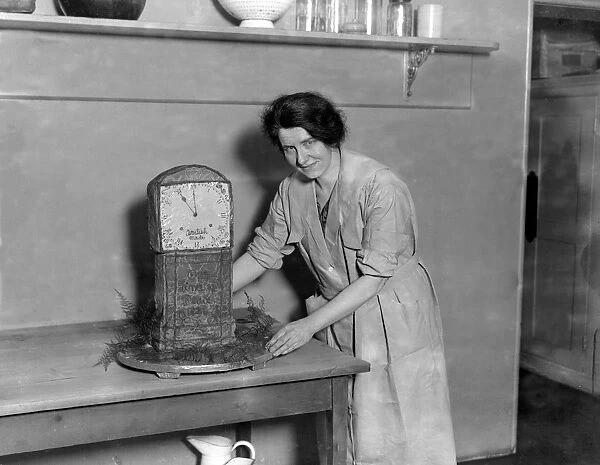 Mrs Barrett (Mrs Stanley Baldwins Cook) with one of her famous confections, a replica
