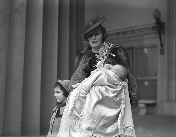 Mrs David Forbes and her infant son after the latters christening at the Guards Chapel