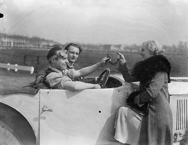 New motor track near London. Miss Rita Cooper, the actress, giving Mr Adrian