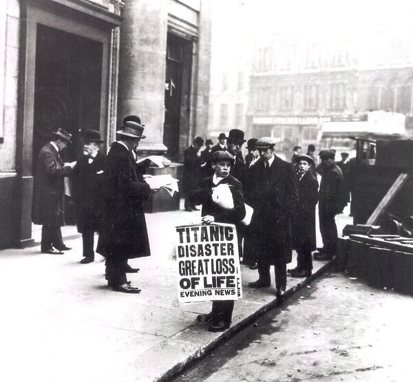 A newspaper boy spreads the news of the sing of the Titanic to bystanders outside