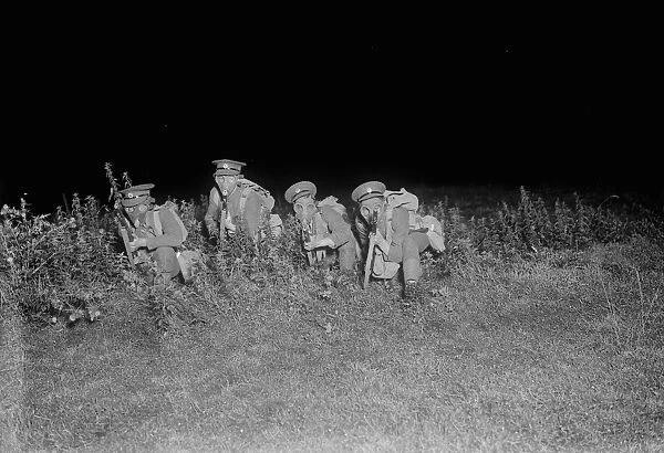 The night advance. Scenes somewhere in Wilts. Infantry wearing gas masks in
