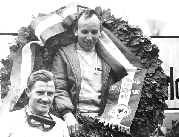 Nurburgring Germany John Surtees with a huge laurel wreath celebrates winning