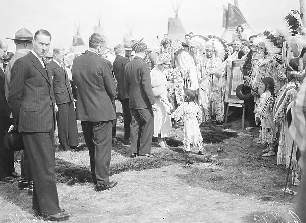 Original caption: The King and Queen visited a Red Indian encampment at Calgary
