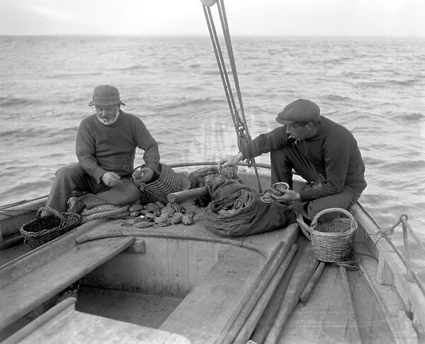 Ormering in the Channel Isles. Fishermen fishing for abalone or ormers. 8 October 1920