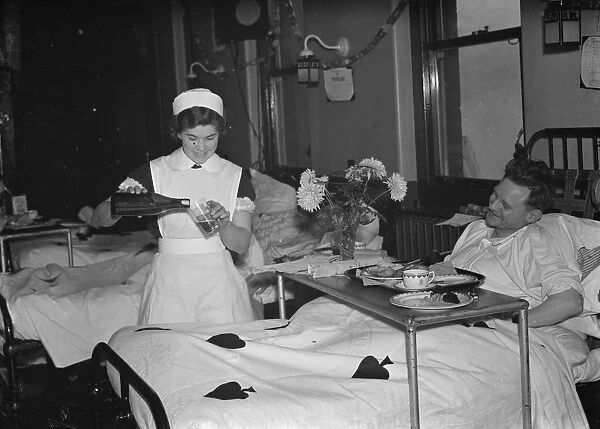 Patients receive a Christmas treat, a glass of beer, at the Livingstone Hospital in Dartford