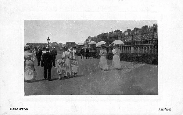 Some people walking along the seafront, Brighton, East Sussex, England. 1904