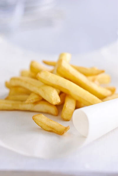 Pile of french fries on greaseproof paper credit: Marie-Louise Avery  /  thePictureKitchen