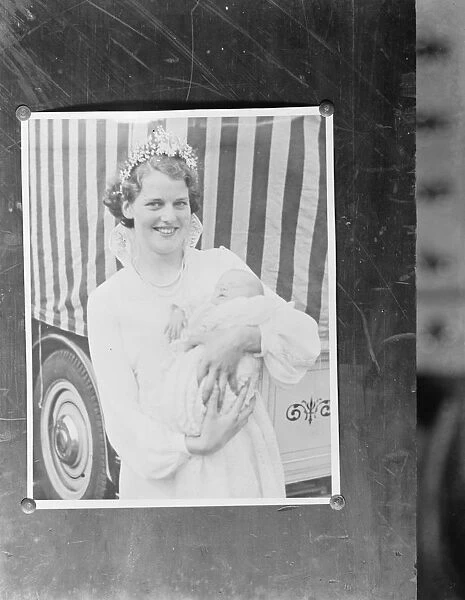 A pinned up photo of the Dartford Carnival Queen holding a baby. 1937