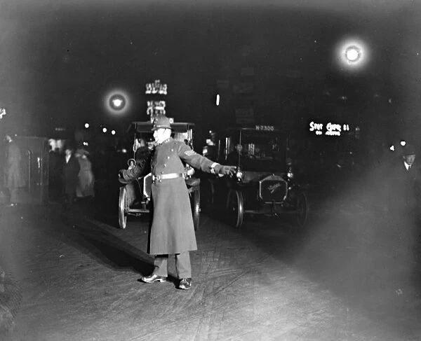 A police officer directing traffic at night in London 12 December 1921