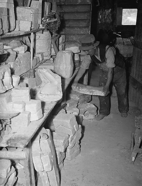 Pottery maker Mr Sadler in his moulding room. 1938