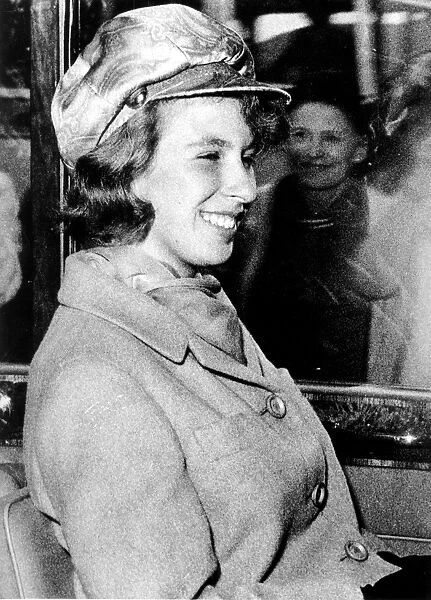 Princess Anne, 16, wearing a peach coloured patterned Beatle Cap and matching scarf