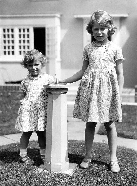Princess Margaret and Princess Elizabeth outside the little house given to her