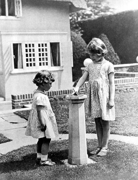 Princesses Elizabeth and Margaret Rose in the grounds of the model house presented