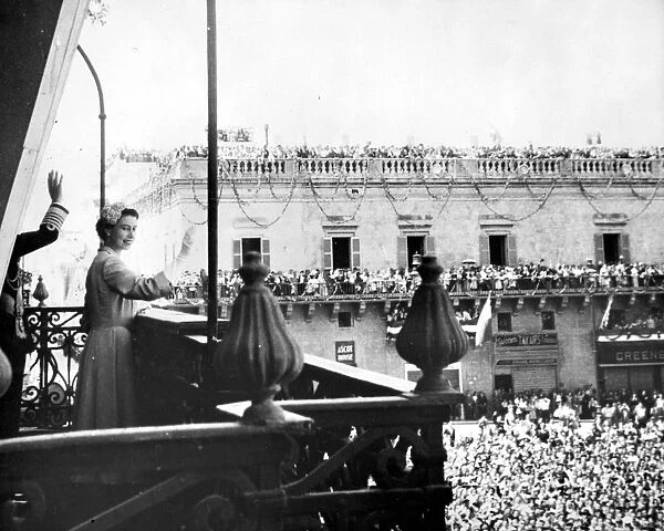 Queen Elizabeth II acknowledging the cheers of the assembled crowds from the Palace