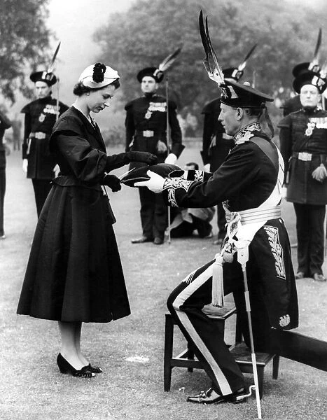 Queen Elizabeth II is presented with a jewelled brooch by the Duke of Bucceluch