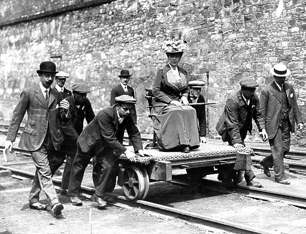 Queen Mary pictured being pushed on a coal trolley after a tour of the coal mine
